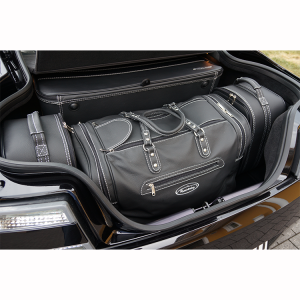 aston Martin v8 vantage coupe behind four in the trunk