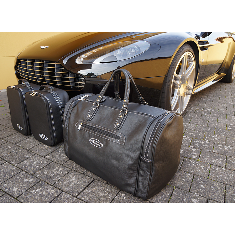 aston martin v8 vantage roadster väskor framför bil