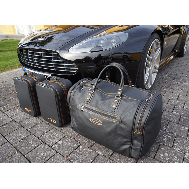 aston martin v8 vantage roadster väskor orange söm framför bil